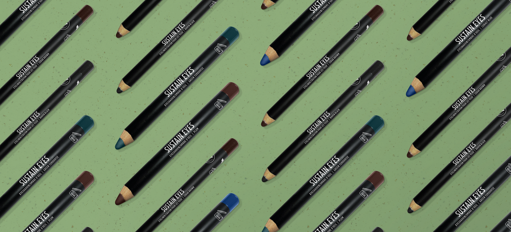 Alternating colours of eyeliner and eyeshadow pencils on a green background